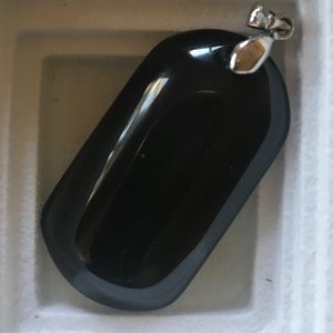 Stone pendant. May be onyx.
